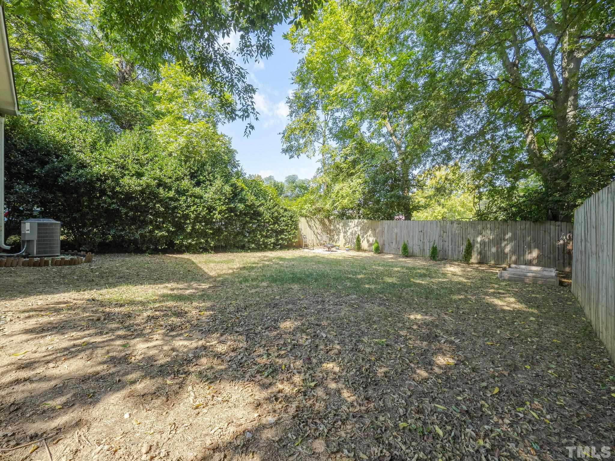 15 Bart Street Raleigh, NC 27610 - Photo 22 of 28 a view of a backyard with large trees and plants