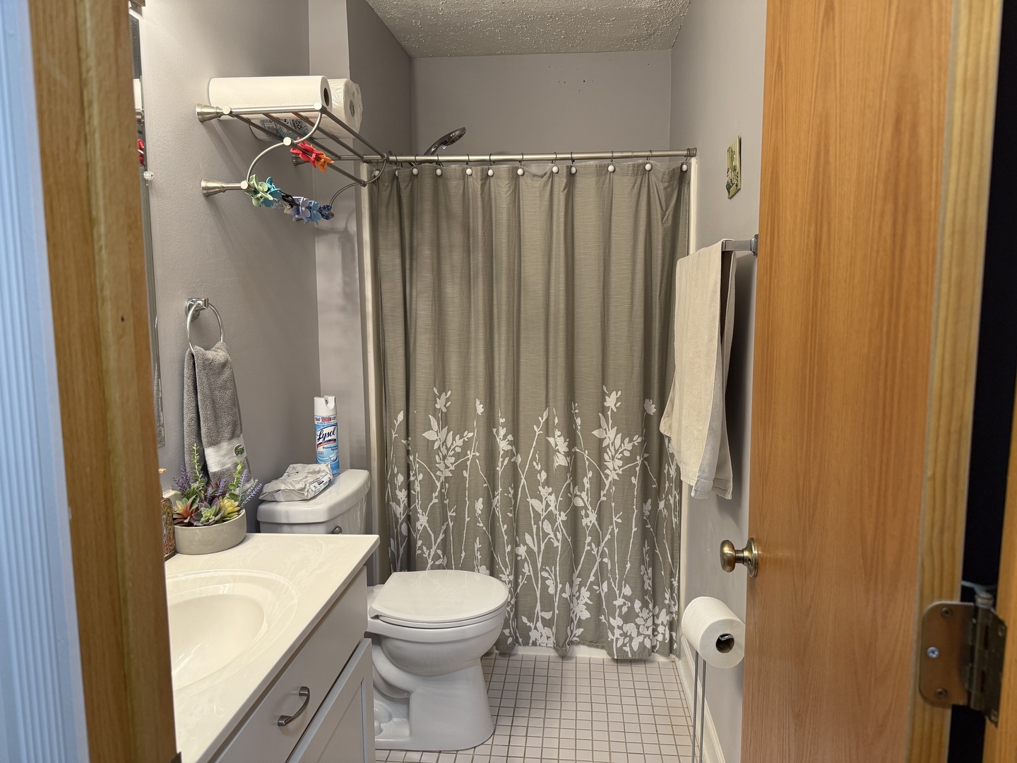 740 Weidner Road, Unit 206 Buffalo Grove, IL 60089 - Photo 14 of 24 a bathroom with a toilet a sink and shower curtain