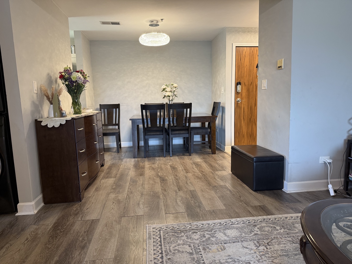 740 Weidner Road, Unit 206 Buffalo Grove, IL 60089 - Photo 4 of 24 a view of a dining room with furniture and wooden floor