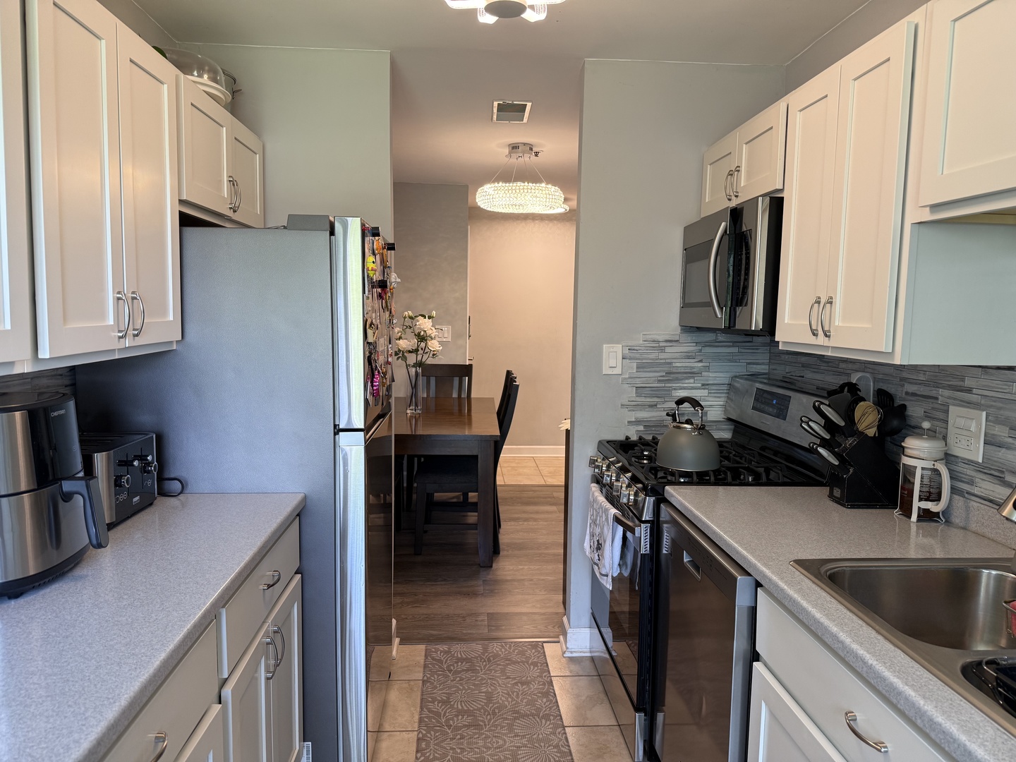 740 Weidner Road, Unit 206 Buffalo Grove, IL 60089 - Photo 7 of 24 a kitchen with stainless steel appliances granite countertop a sink stove and refrigerator