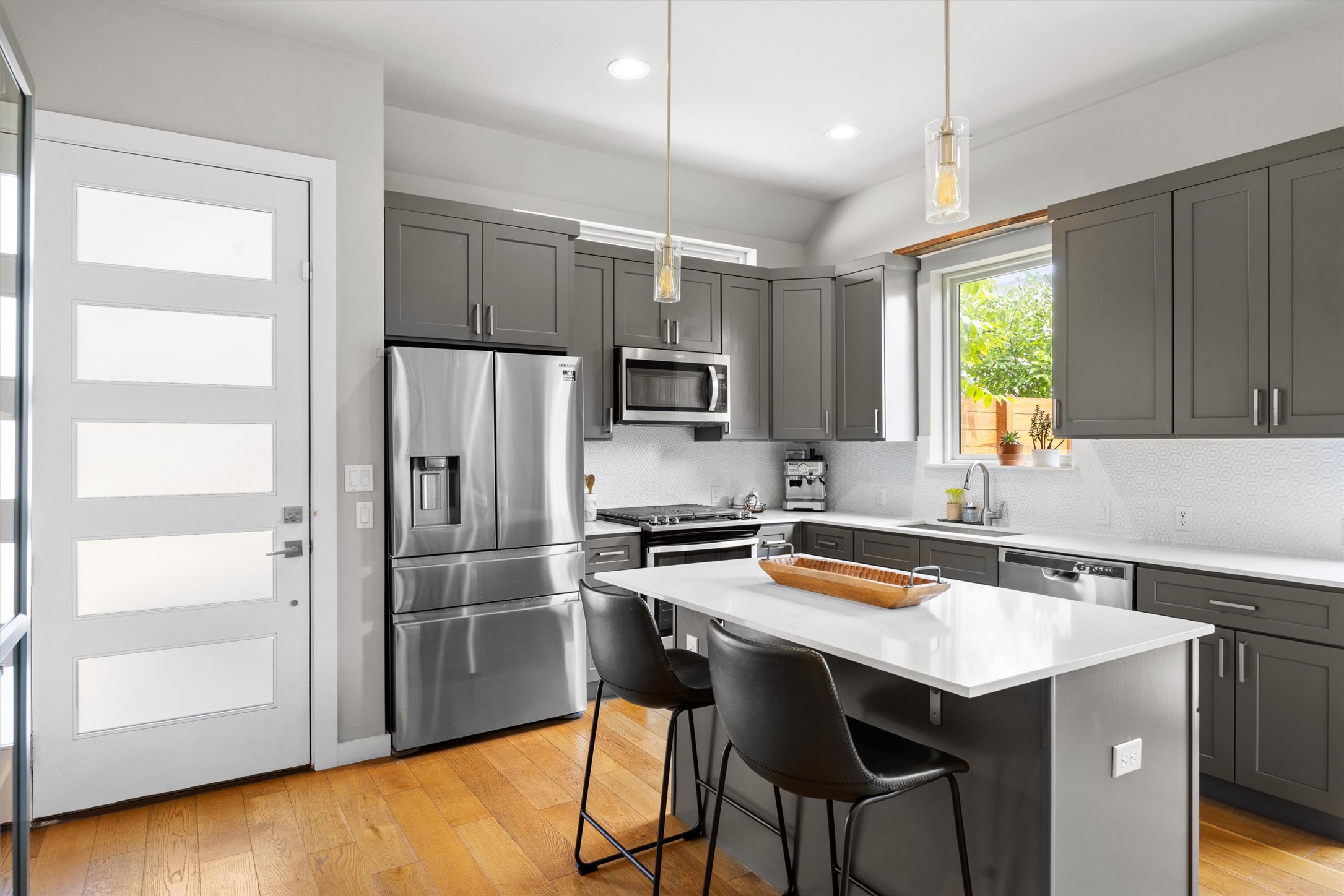 1116 Stobaugh Street, Unit B Austin, TX 78757 - Photo 11 of 38 Pendant lighting and soft gray tones give the kitchen a fresh, contemporary feel.