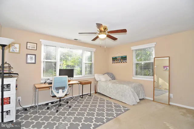 a bedroom with a bed and a chair