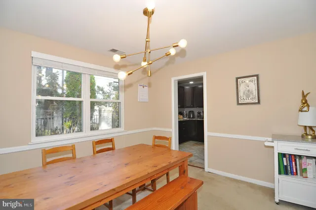 a living room with furniture a window and a flat screen tv