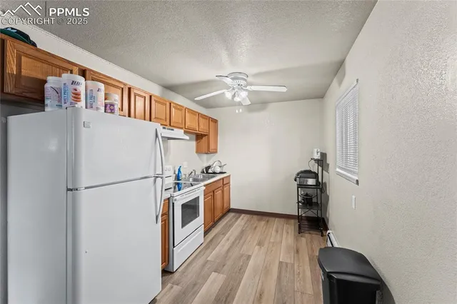 a white refrigerator freezer a dishwasher and a stove top oven