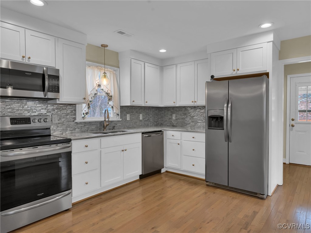 12110 Bailey Bridge Road Midlothian, VA 23112 - Photo 13 of 21 Kitchen with white cabinetry, sink, hanging light