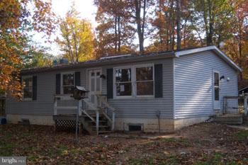 732 Shades Road Berkeley Springs, WV 25411 - Photo 5 of 8 a backyard of a house with wooden fence and large trees