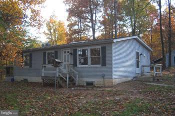732 Shades Road Berkeley Springs, WV 25411 - Photo 8 of 8 a view of a house with a yard