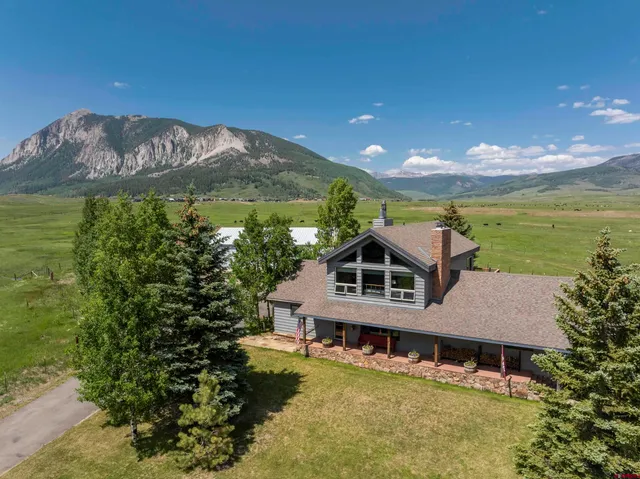 a aerial view of a house with a garden and a yard