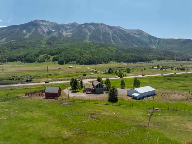 a view of a lush green hillside and houses