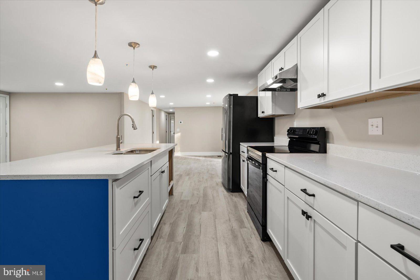 36451-3 3 Bridges Road Willards, MD 21874 - Photo 11 of 44 a kitchen with kitchen island granite countertop a sink a counter space and cabinets