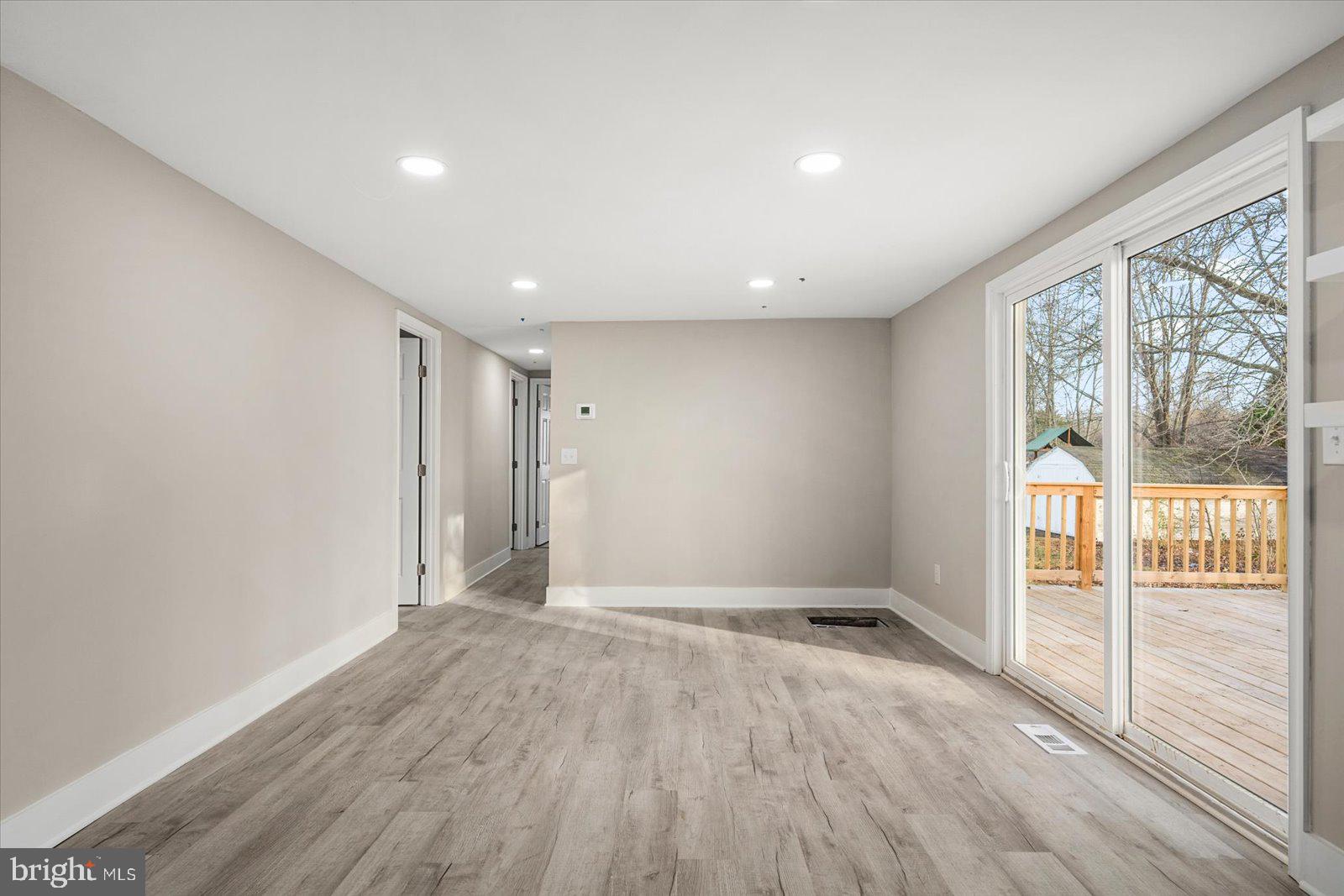 36451-3 3 Bridges Road Willards, MD 21874 - Photo 15 of 44 a view of an empty room with wooden floor and a window