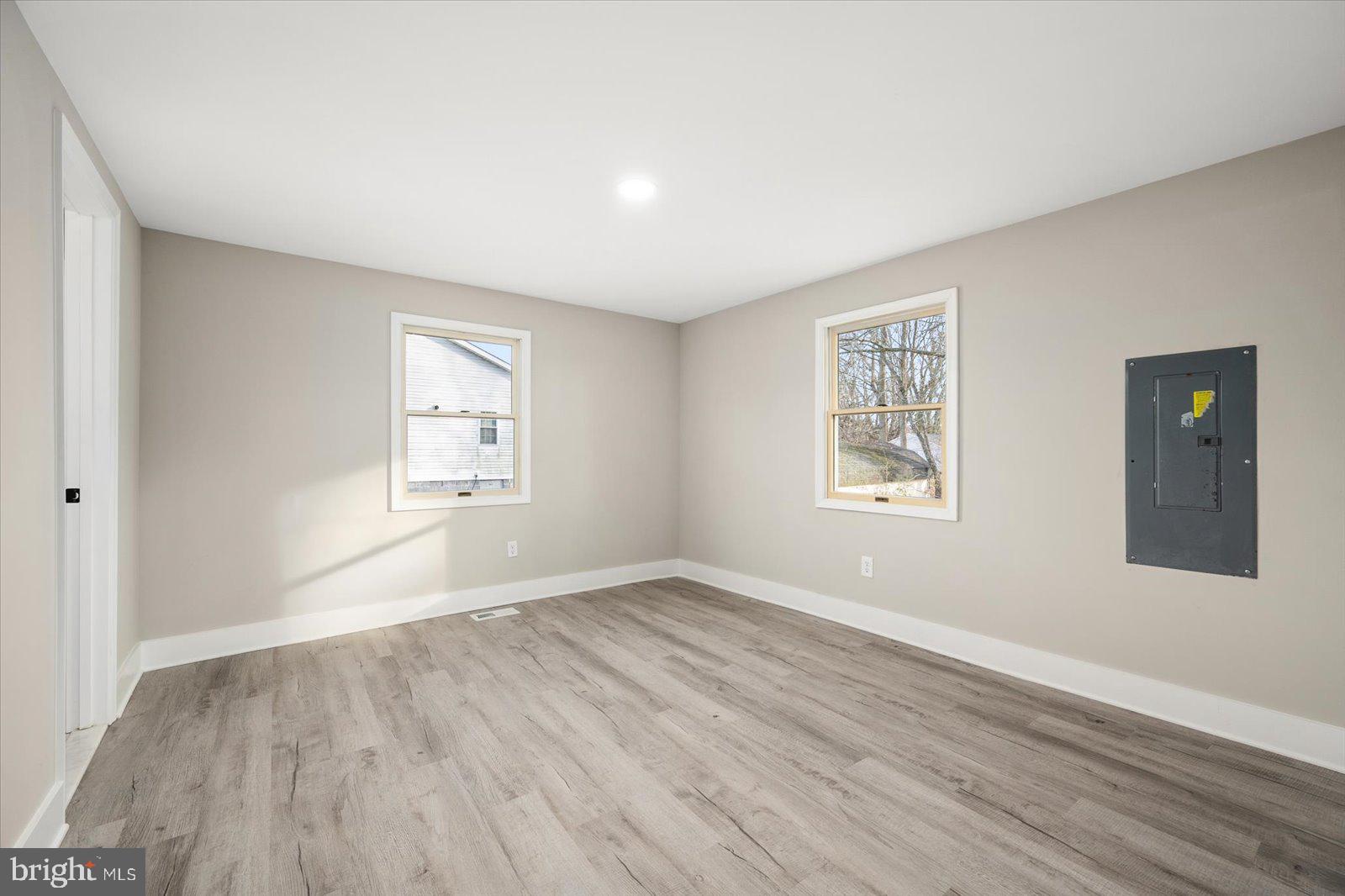 36451-3 3 Bridges Road Willards, MD 21874 - Photo 17 of 44 an empty room with wooden floor and windows