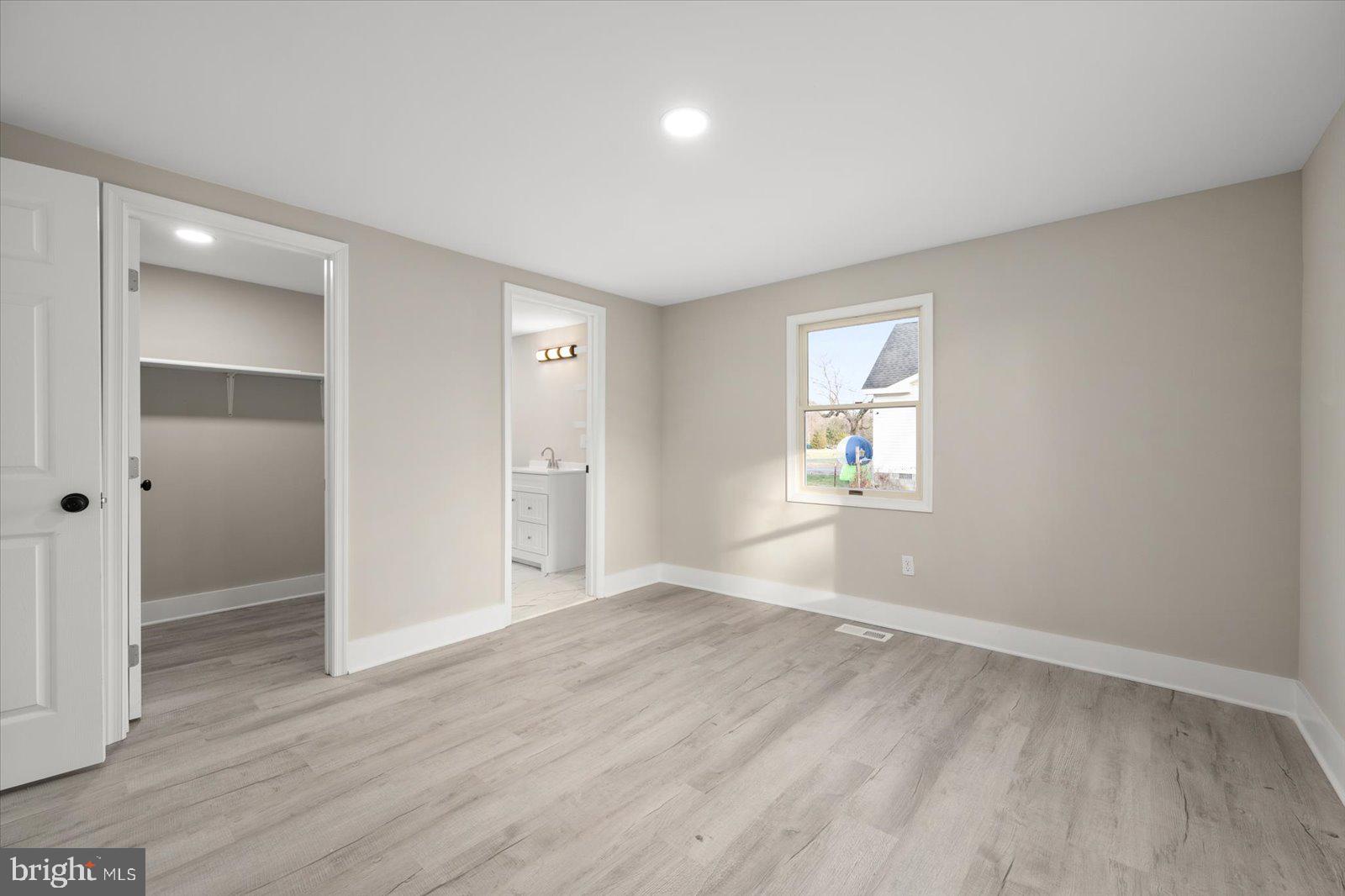 36451-3 3 Bridges Road Willards, MD 21874 - Photo 18 of 44 an empty room with wooden floor and windows