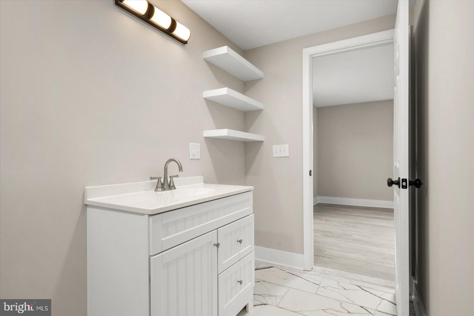 36451-3 3 Bridges Road Willards, MD 21874 - Photo 23 of 44 a bathroom with a sink and a mirror