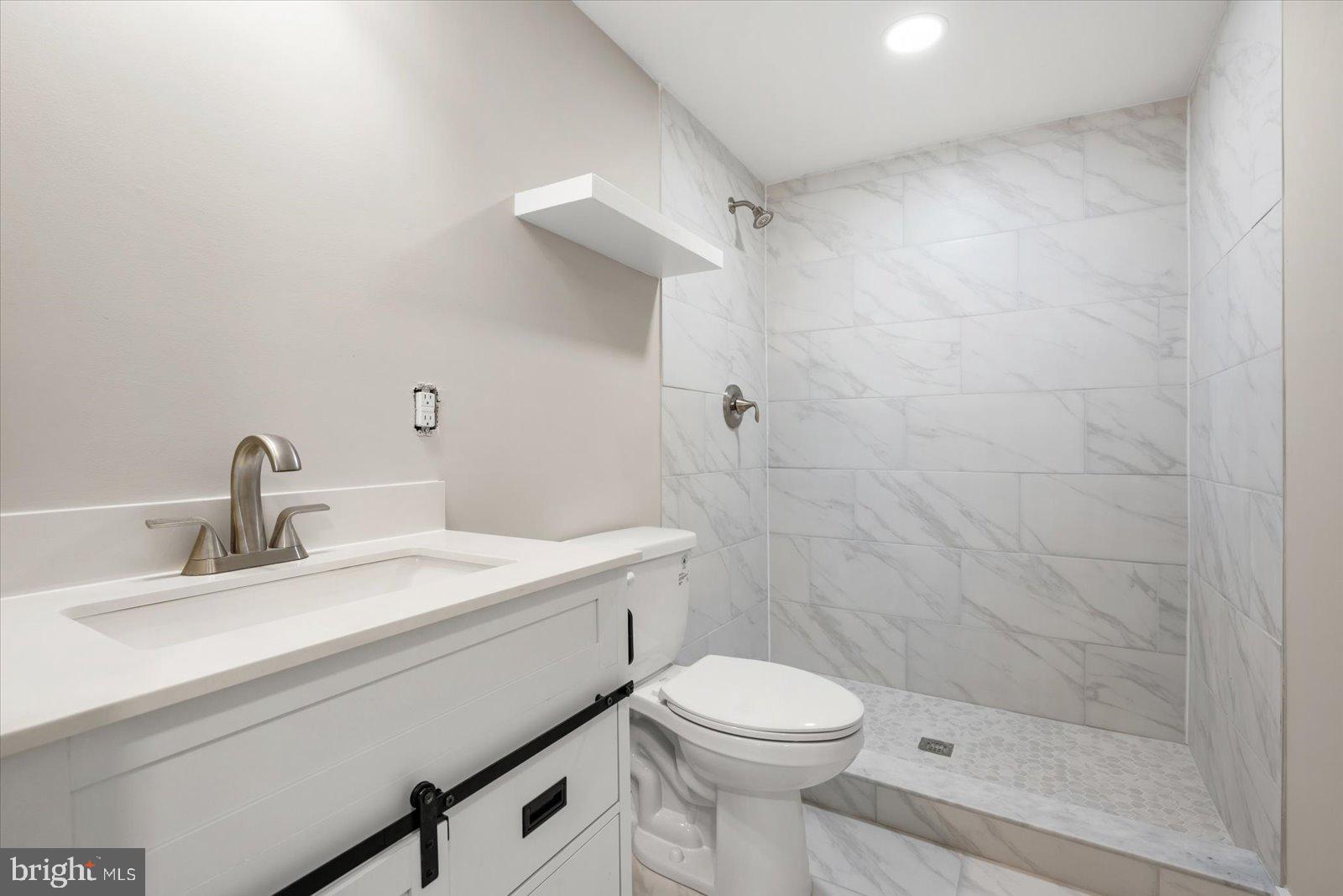 36451-3 3 Bridges Road Willards, MD 21874 - Photo 26 of 44 a bathroom with a sink a toilet and shower