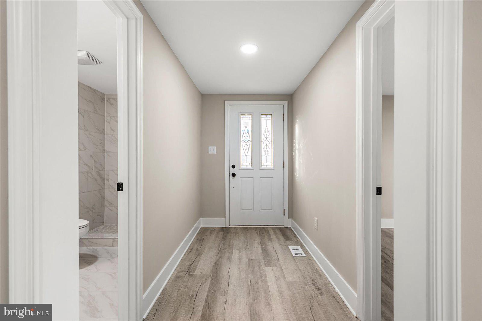36451-3 3 Bridges Road Willards, MD 21874 - Photo 31 of 44 a view of a hallway with wooden floor and a bathroom