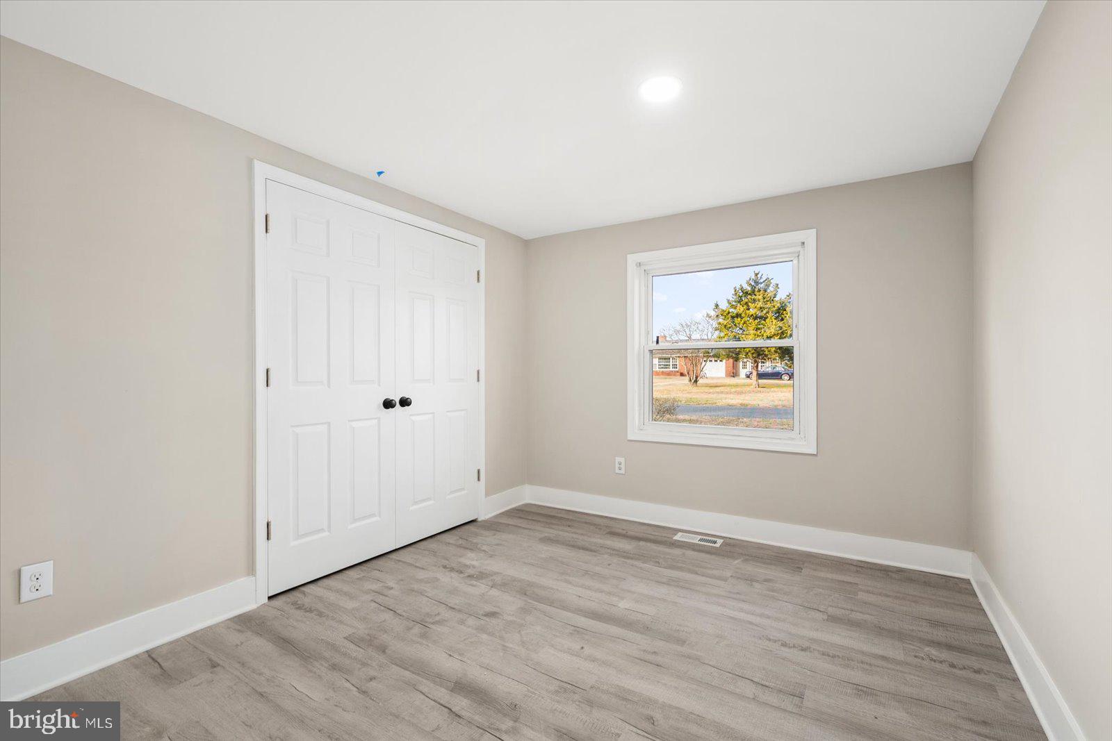 36451-3 3 Bridges Road Willards, MD 21874 - Photo 32 of 44 an empty room with window and wooden floor