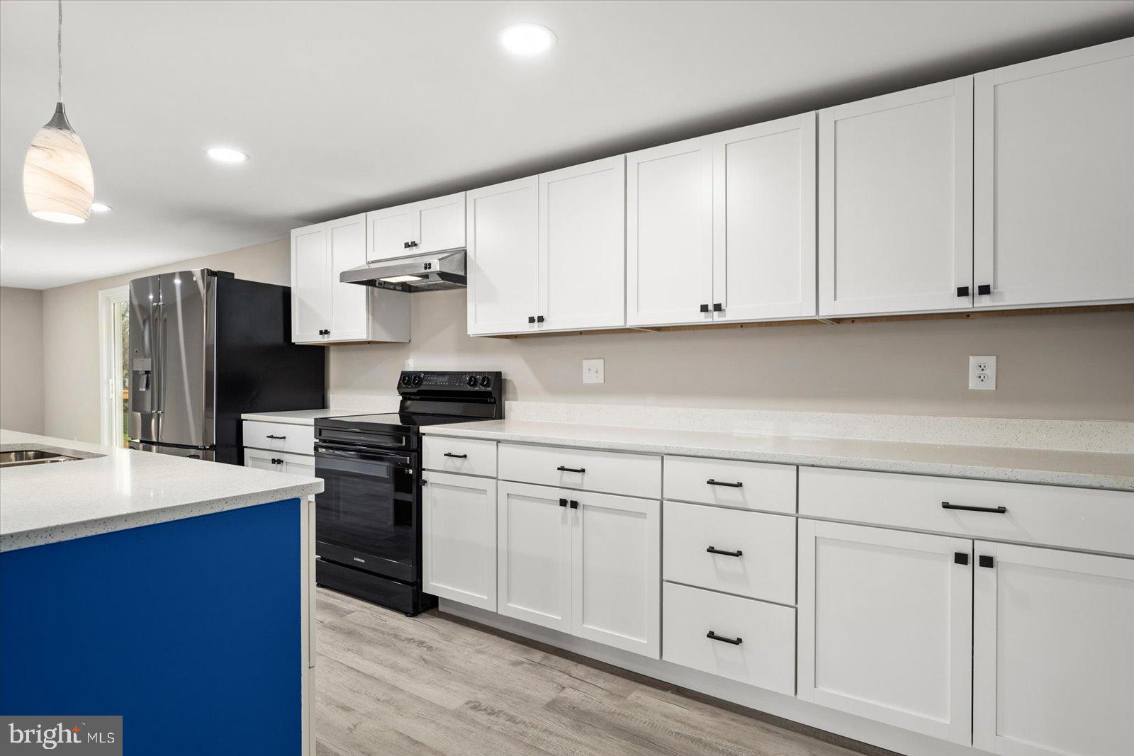 36451-3 3 Bridges Road Willards, MD 21874 - Photo 10 of 44 a kitchen with white cabinets and stainless steel appliances