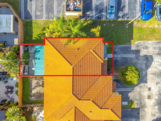 an aerial view of residential houses with outdoor space and ocean view