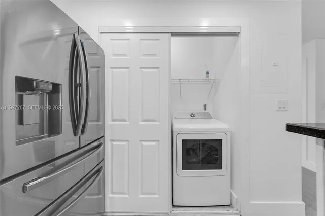 a kitchen with stainless steel appliances granite countertop a refrigerator and a sink