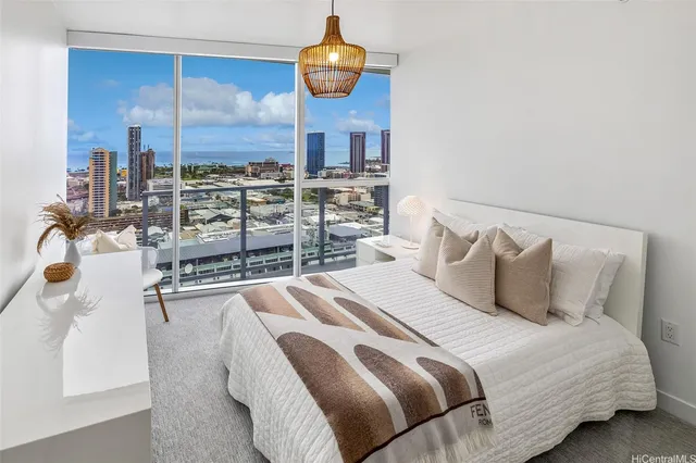 a bedroom with a large bed and a chandelier