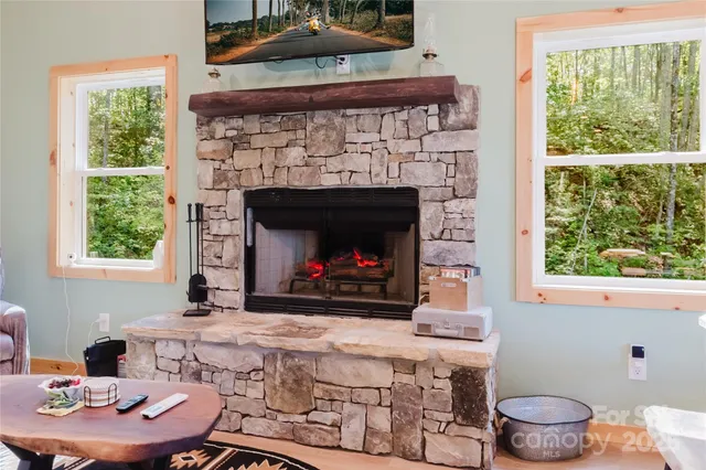 a living room with a fireplace and a table
