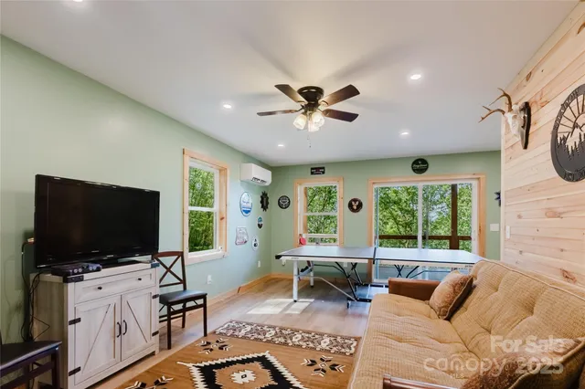 a living room with furniture and a flat screen tv