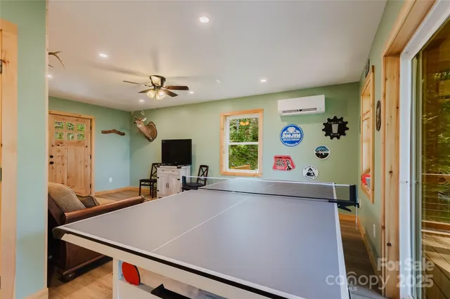 a room with furniture a flat screen tv and a window