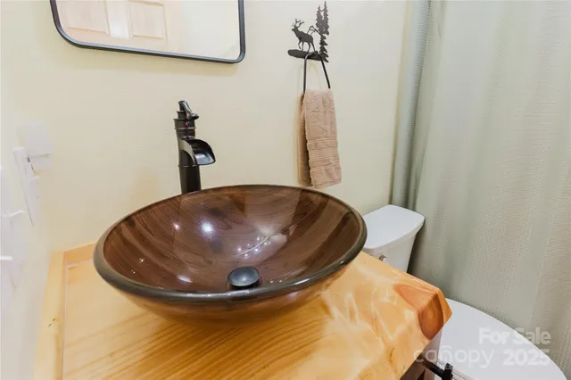 a view of a room with a sink and wooden floor