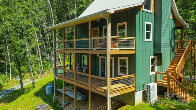 a view of a house with a window and wooden fence