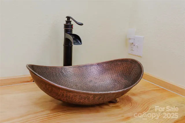 a balcony with wooden floor table and chairs