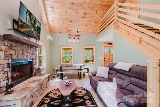 a living room with furniture a fireplace and a large window
