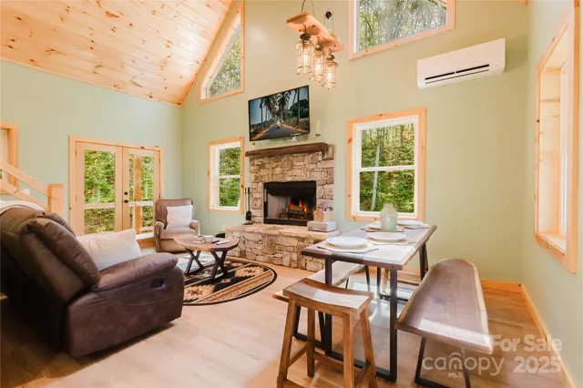 a living room with furniture fireplace and a large window