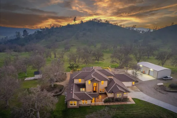 a front view of a house with a garden and yard