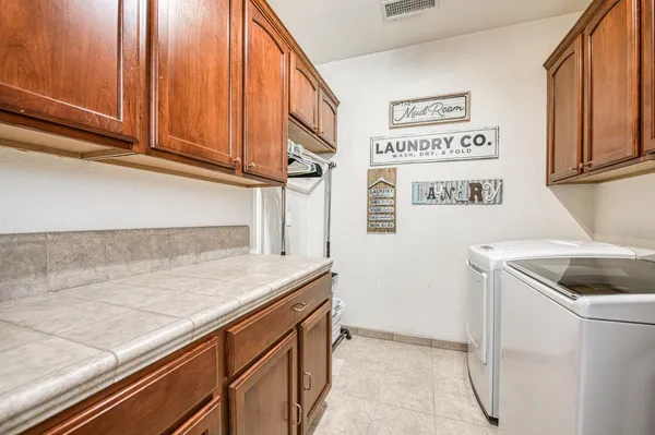 a spacious bathroom with a double vanity sink a large mirror and a shower