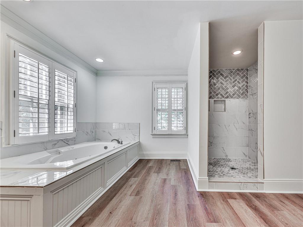 633 Butterworth Road Canton, GA 30114 - Photo 27 of 55 a bathroom with a granite countertop sink a mirror and a bathtub