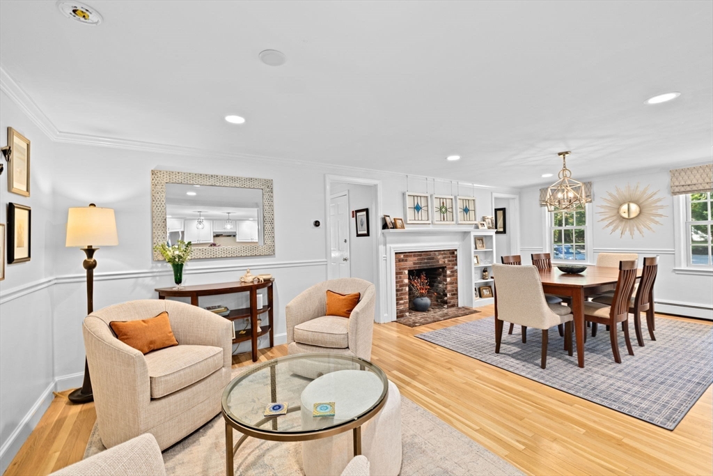 23 Mast Hill Road Hingham, MA 02043 - Photo 14 of 42 a living room with furniture a fireplace and a table
