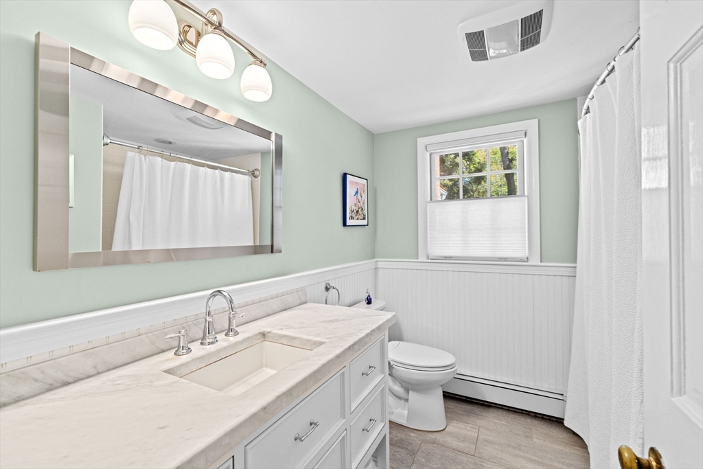 23 Mast Hill Road Hingham, MA 02043 - Photo 19 of 42 a bathroom with a granite countertop toilet a sink and a mirror