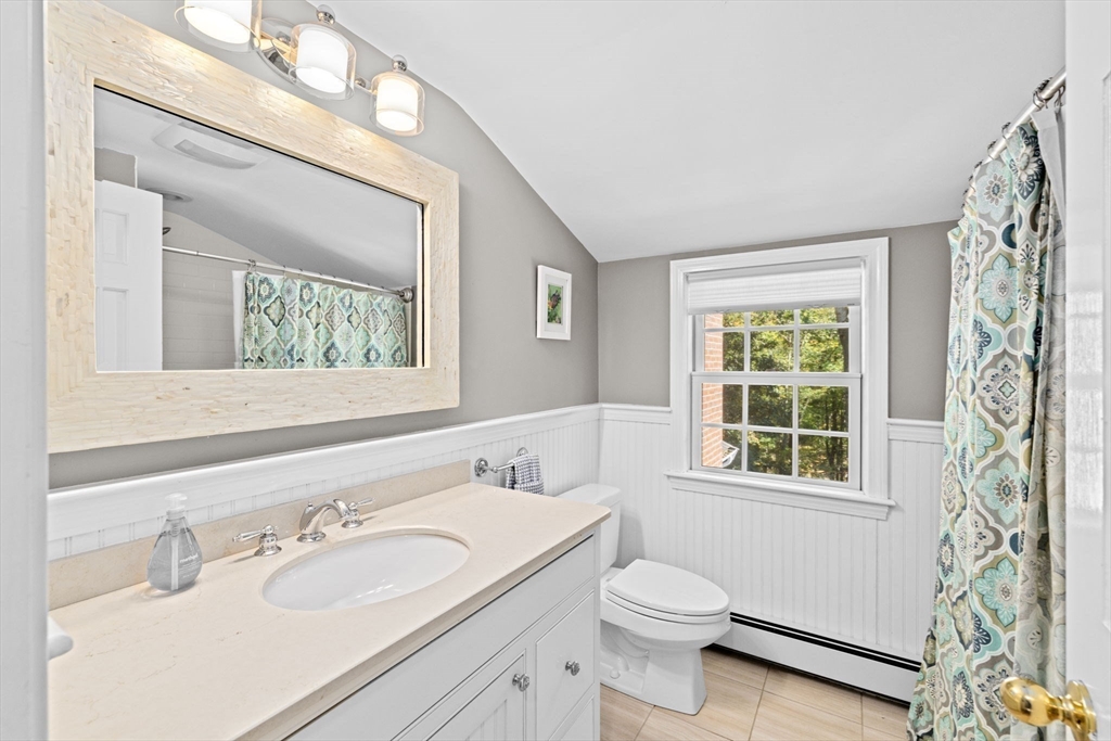 23 Mast Hill Road Hingham, MA 02043 - Photo 27 of 42 a bathroom with a toilet a sink a mirror a window and vanity