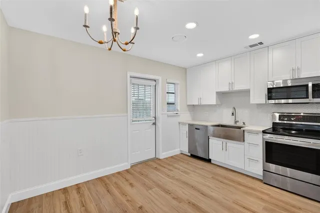 a kitchen with cabinets a sink and stainless steel appliances