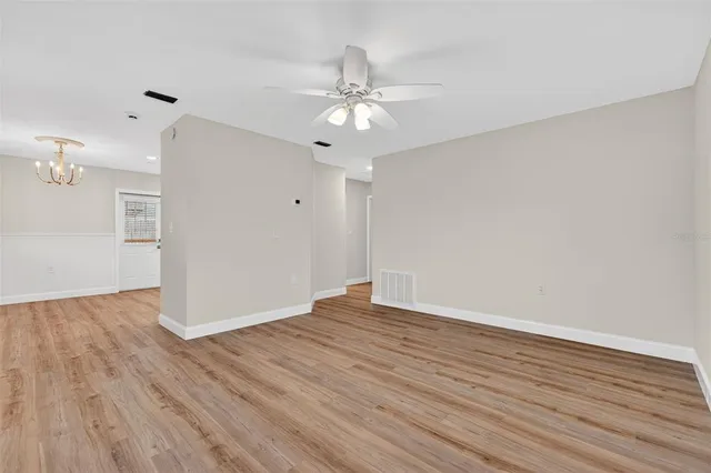 wooden floor in an empty room with a window
