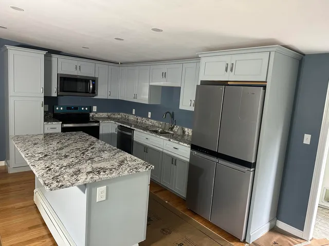 a kitchen with a sink stove and refrigerator