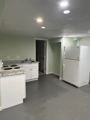 a kitchen with a stove a refrigerator and a sink