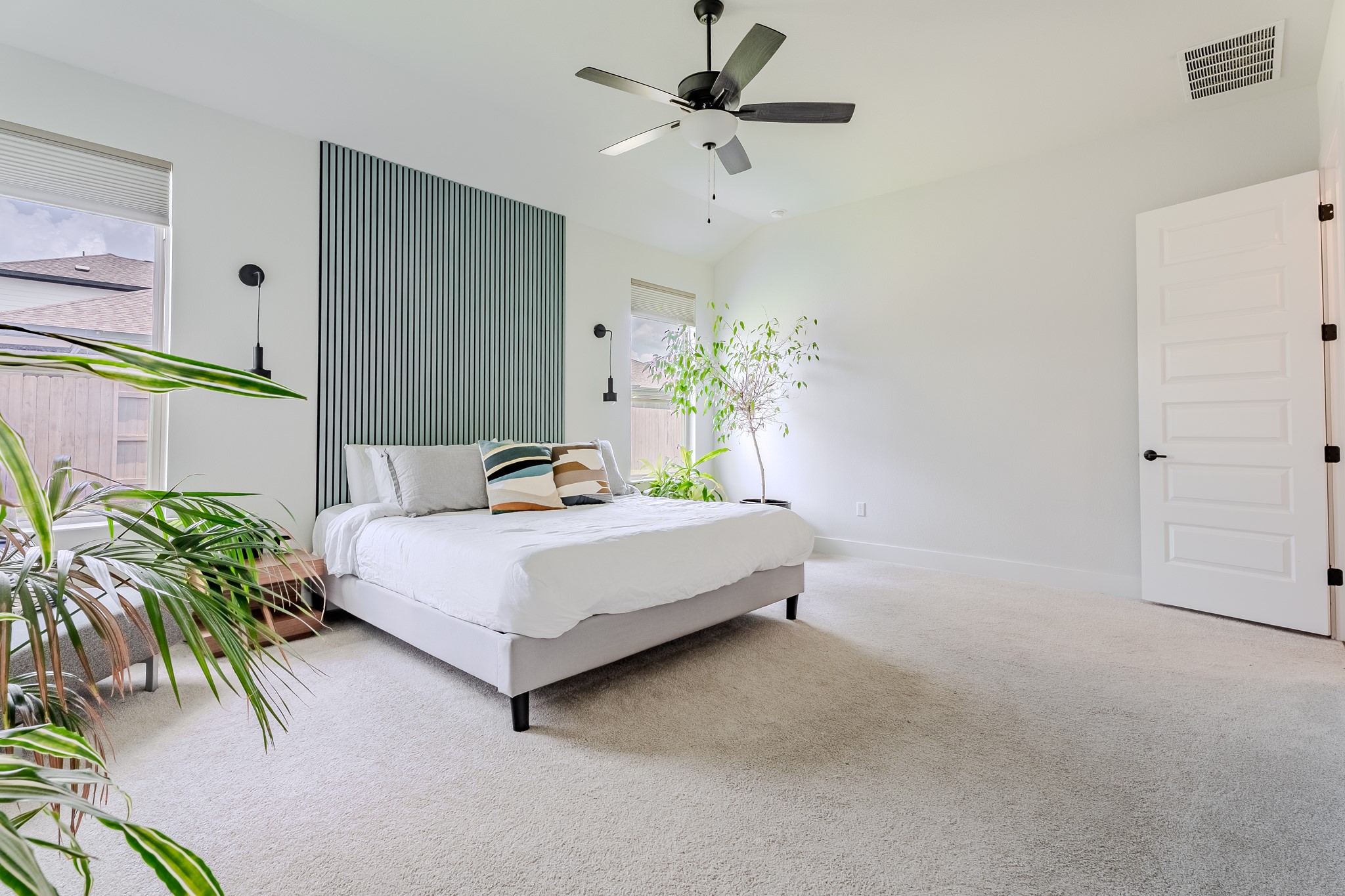 8109 Edmondson Bend Austin, TX 78744 - Photo 20 of 38 A tranquil primary bedroom features plush carpeting, a modern ceiling fan, and accent lighting.