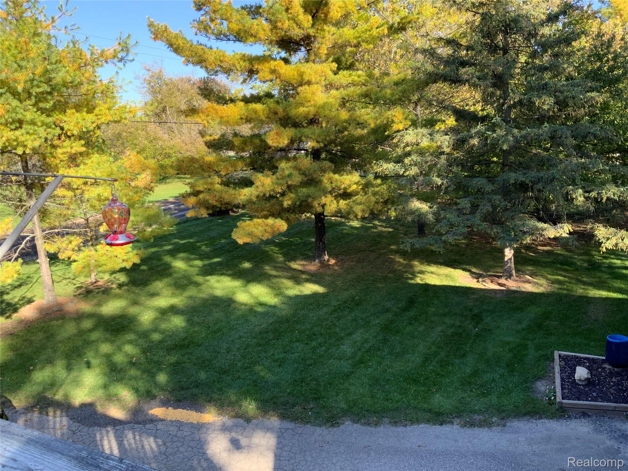 3828 Morgan Road Lake Orion, MI 48359 - Photo 28 of 39 Manicured lawn with mature trees and paved area