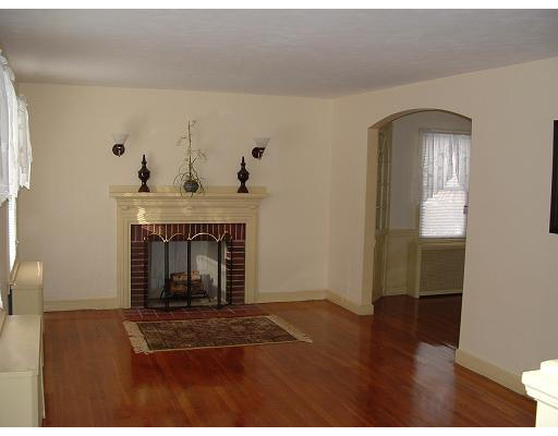 69 Park Avenue Worcester, MA 01605 - Photo 2 of 7 a living room with a fireplace and wooden floor