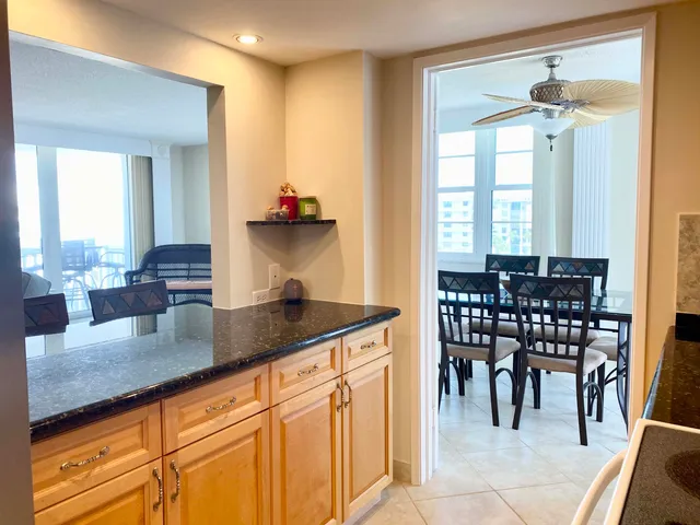 a kitchen with granite countertop a sink and cabinets