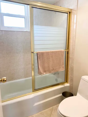a bathroom with a toilet and a bathtub