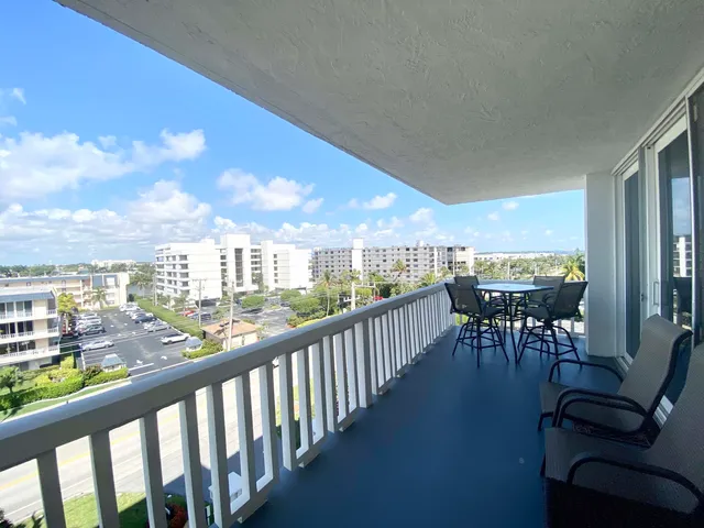 a view of a chairs and table in patio