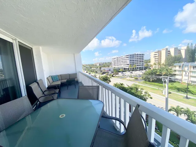 a view of a balcony with furniture